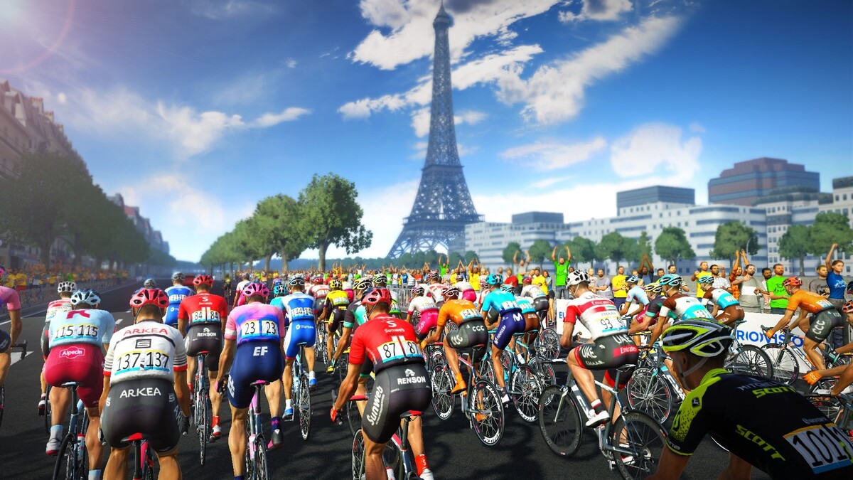 Fotografía en acción de los ciclistas del Tour de Francia recorriendo las pintorescas calles de una ciudad francesa.